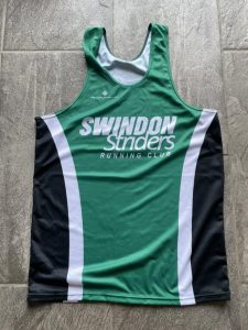 photograph of Striders running vest in green, white and black